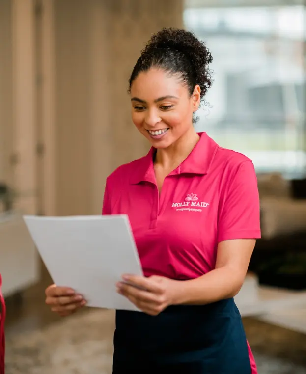 Molly Maid professional reviewing a client's custom cleaning plan.