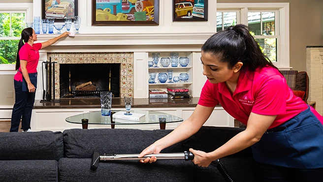 Two Molly Maid professionals cleaning an Airbnb home.